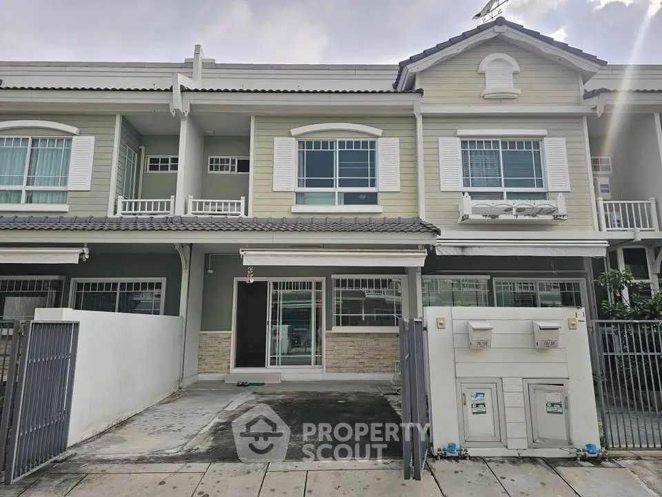 Charming two-story townhouse with classic shutters and spacious driveway.