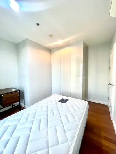 Bright bedroom with minimalist design and wooden flooring