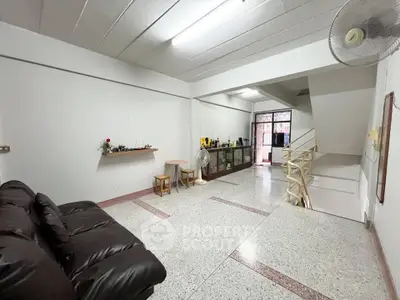 Spacious living room with modern decor and ample natural light