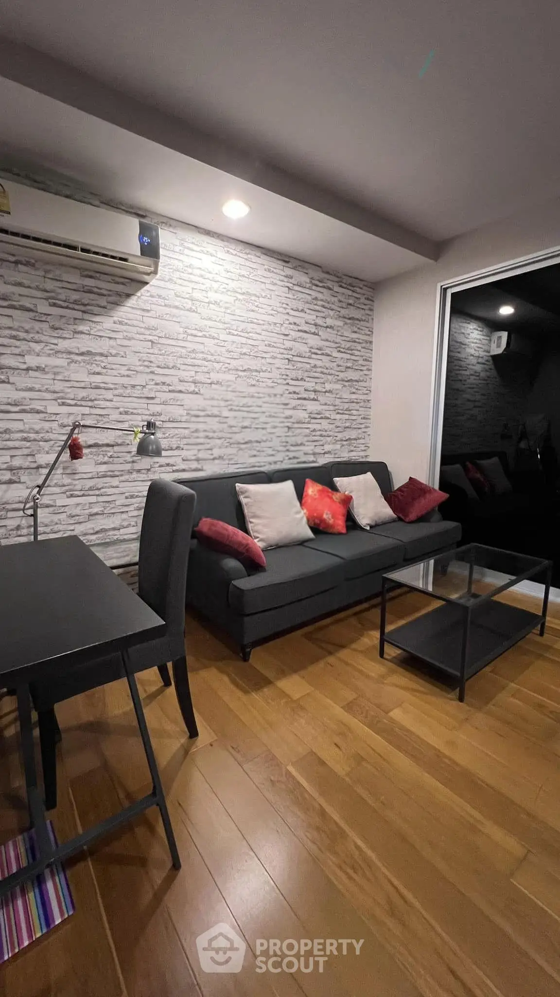 Modern living room with stylish decor and cozy seating area, featuring a sleek sofa and elegant lighting.