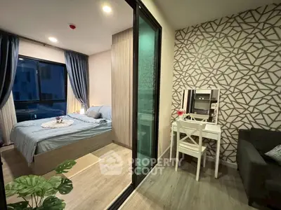 Modern bedroom with stylish decor and cozy ambiance, featuring a study nook and large window.