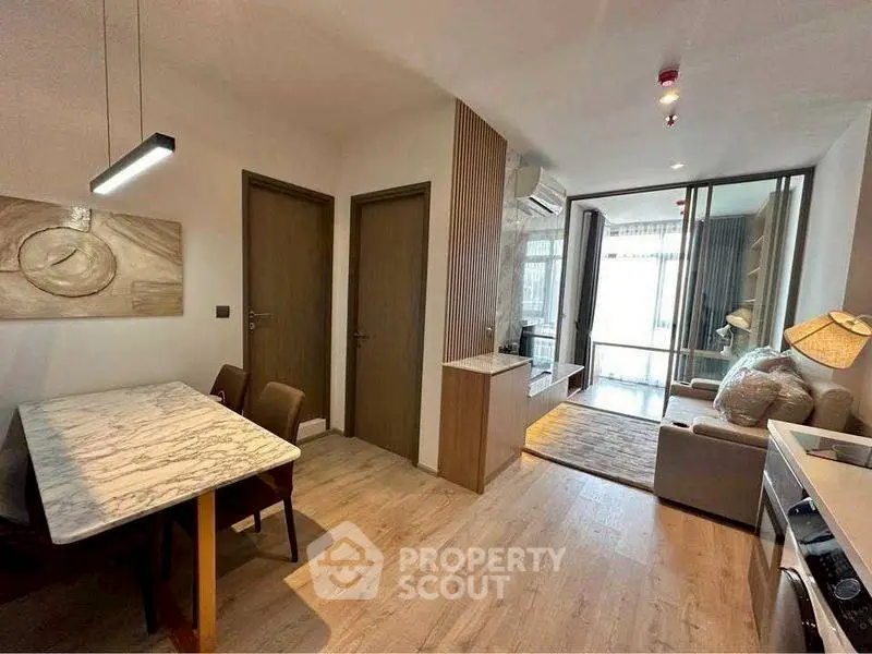 Modern open-plan living room with stylish dining area and natural light.