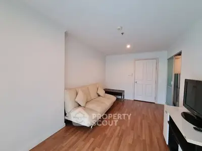 Spacious living room with modern decor and wooden flooring