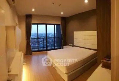 Spacious bedroom with panoramic city view and modern decor