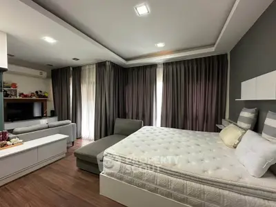 Spacious bedroom with modern decor and ample natural light