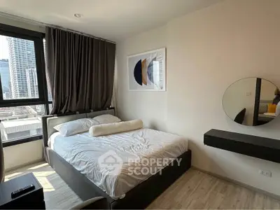 Modern bedroom with city view, featuring stylish decor and natural light.