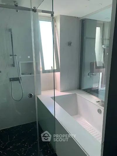 Luxurious bathroom with modern bathtub and sleek glass shower enclosure