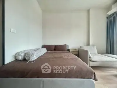 Modern bedroom with cozy bed and stylish chaise lounge