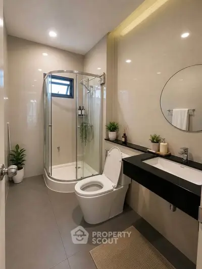 Modern bathroom with glass shower, sleek fixtures, and elegant decor