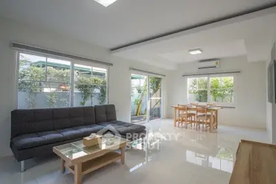Spacious modern living room with large windows and garden view
