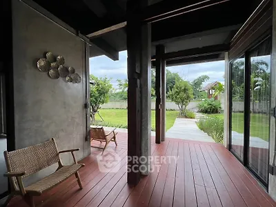 Charming patio with wooden deck and garden view, perfect for relaxation and outdoor enjoyment.