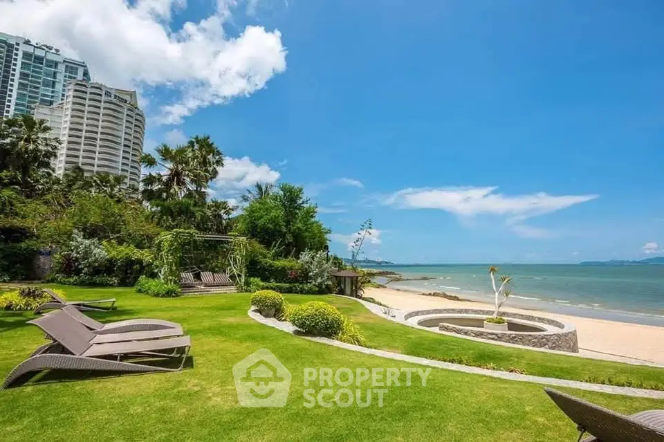 Luxurious beachfront property with lush garden and stunning ocean view, perfect for relaxation and leisure.