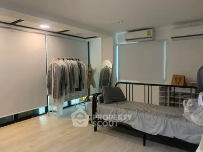 Spacious bedroom with modern decor and ample natural light