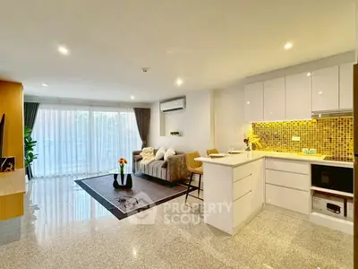 Modern open-plan living room with stylish kitchen and cozy seating area