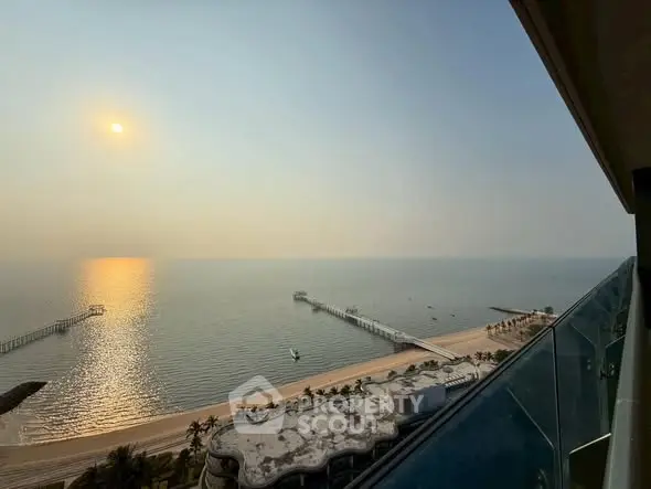 Stunning ocean view from high-rise balcony at sunset, perfect for luxury living.