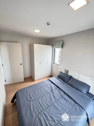 Cozy bedroom with modern decor and ample natural light