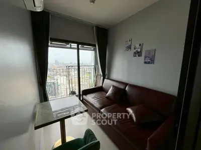Cozy living room with city view and modern furnishings in high-rise apartment.