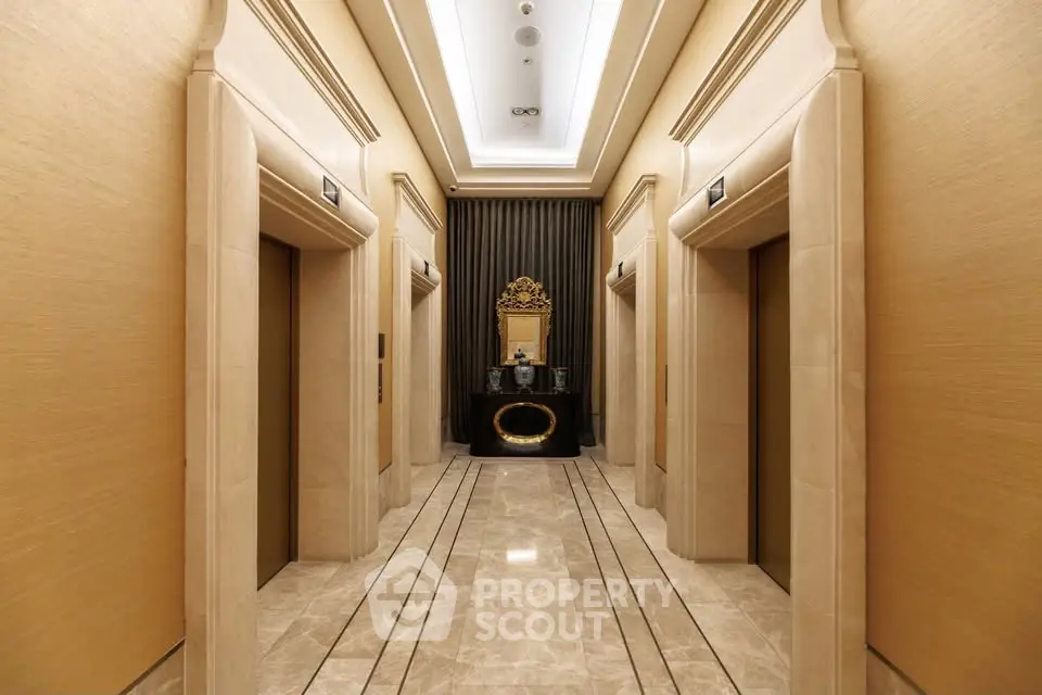 Luxurious elevator lobby with elegant marble flooring and ornate mirror