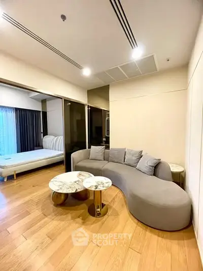 Modern living room with stylish curved sofa and elegant wooden flooring