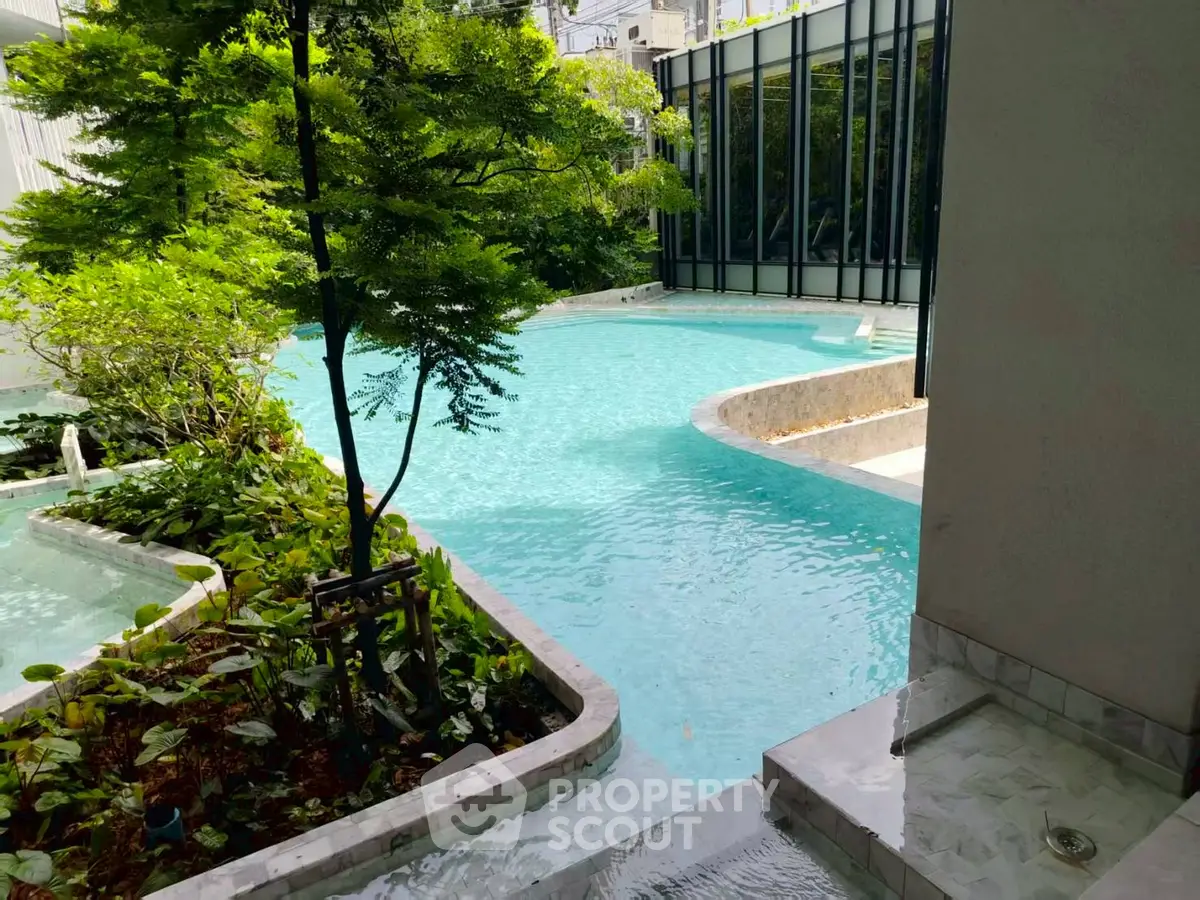 Luxurious poolside view with lush greenery and modern architecture