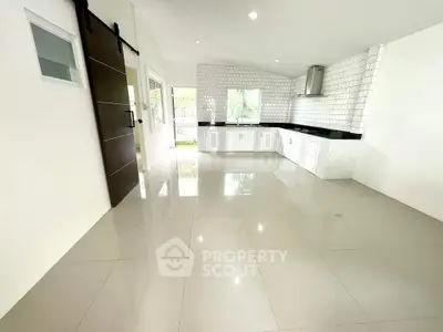 Spacious modern kitchen with sleek tile flooring and open layout design.