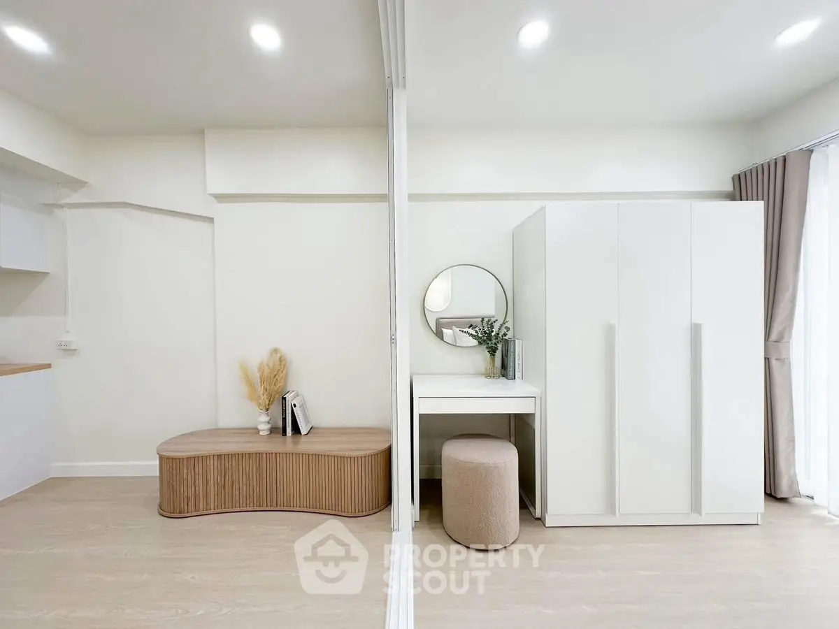 Modern minimalist bedroom with sleek white furniture and natural light