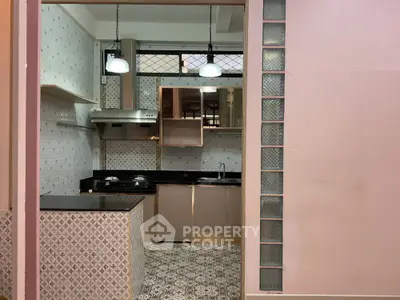 Charming kitchen with modern design, featuring gas stove and elegant tile work.