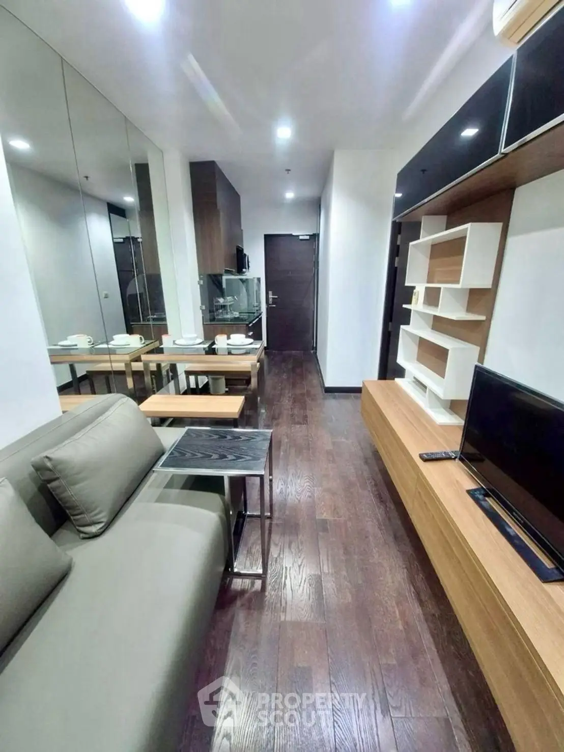 Modern living room with sleek design, hardwood floors, and stylish furniture in a contemporary apartment.