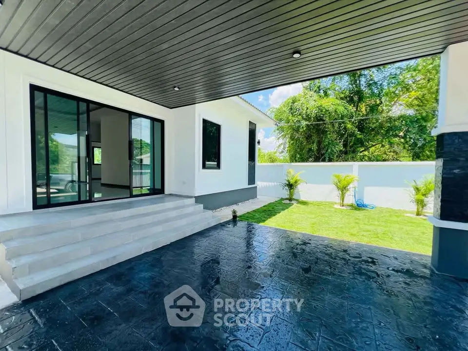 Modern home exterior with sleek patio and lush garden view