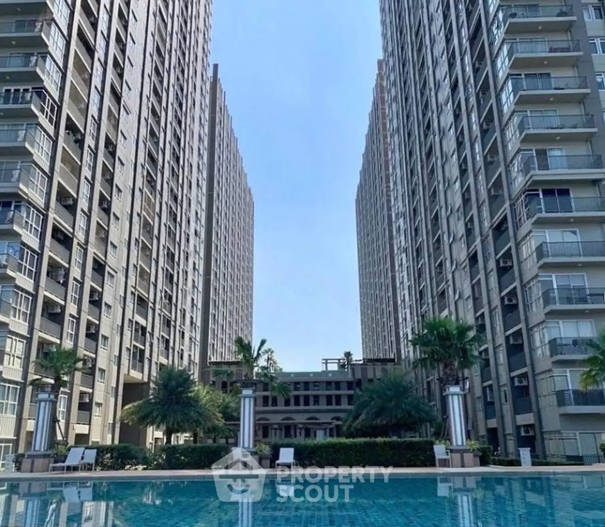 Luxurious high-rise apartment complex with stunning pool and modern architecture.