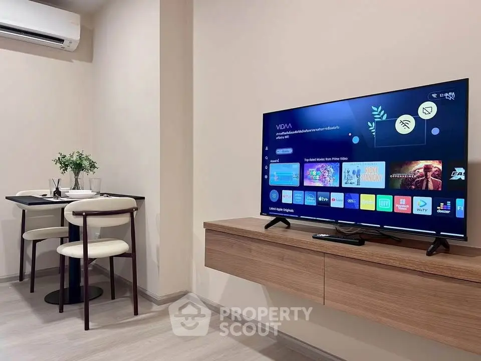 Modern living room with sleek TV setup and cozy dining area