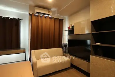 Cozy living room with modern furniture and air conditioning, perfect for relaxation.