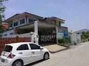 Charming suburban house with driveway and parked car, ideal for family living.