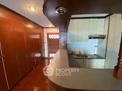 Spacious kitchen with closed layout and sleek wooden cabinetry