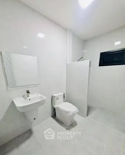 Modern minimalist bathroom with sleek fixtures and white tiles