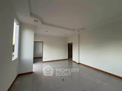 Spacious unfurnished room with large windows and modern ceiling lights, perfect for customization.