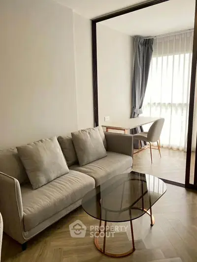 Modern living room with elegant glass coffee table and cozy seating area