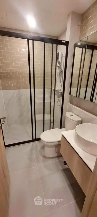 Modern bathroom with glass shower and sleek fixtures