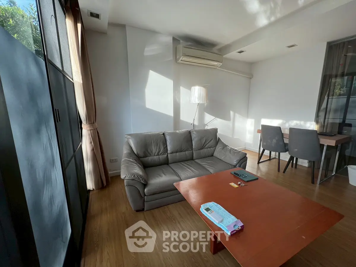 Modern living room with sleek furniture and natural light, perfect for relaxation and entertaining.