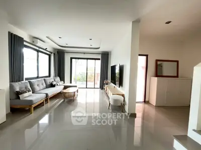 Spacious modern living room with sleek furniture and large windows