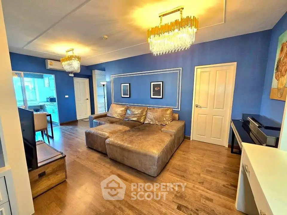 Luxurious living room with elegant lighting and modern decor in vibrant blue tones.