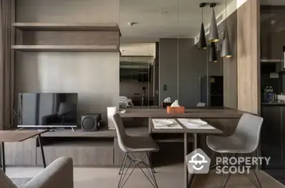 Modern open-plan living space with sleek furniture and integrated kitchen, perfect for entertaining and relaxation.