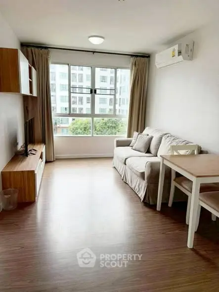 Bright living room with modern furniture and large window view