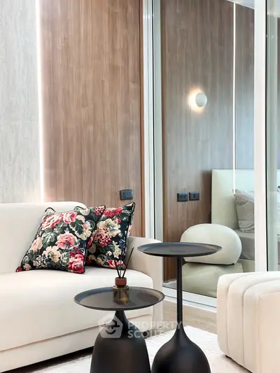 Modern living room with elegant decor and stylish furniture, featuring a cozy sofa and chic side tables.