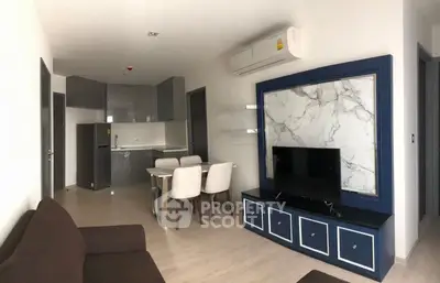 Modern living room with sleek furniture and open kitchen layout