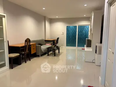 Spacious living room with modern furniture and large windows for natural light.