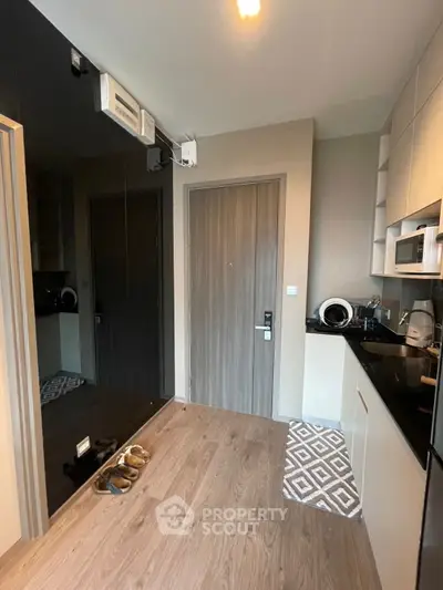 Modern kitchen with sleek cabinetry and appliances in a compact layout