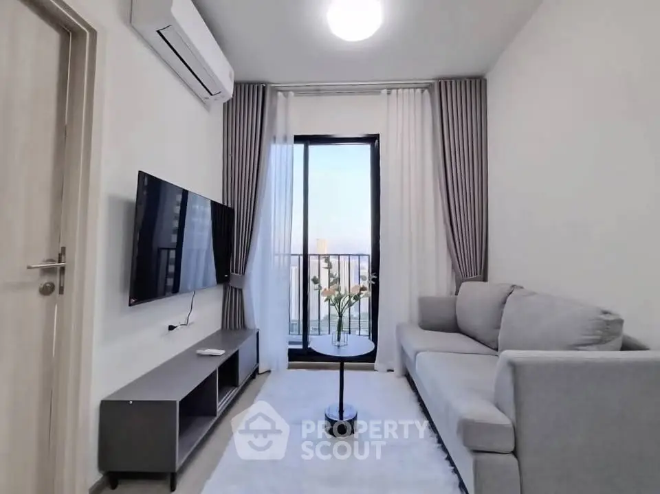 Modern living room with balcony view, sleek furniture, and stylish decor