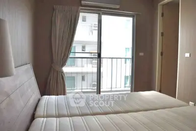 Cozy bedroom with twin beds and balcony view in modern apartment