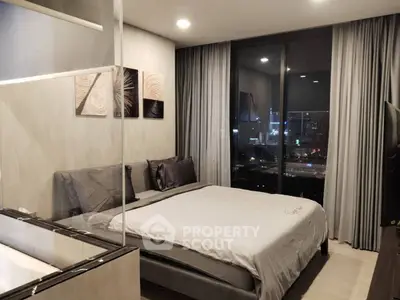 Luxurious bedroom with city view, modern decor, and elegant lighting in a high-rise apartment.